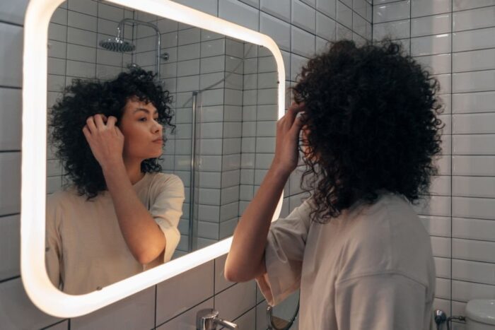 Benefits and Practical Applications - women using smart LED mirror